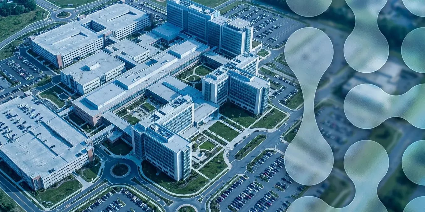 Microsegmentation in healthcare: aerial view of a modern hospital campus with identity-based network segmentation node graphics
