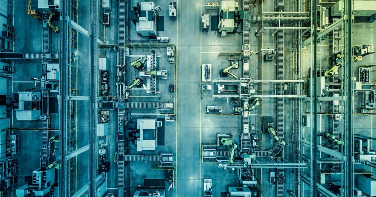 Aerial view of modern manufacturing facility with teal gradient overlay representing OT security and microsegmentation