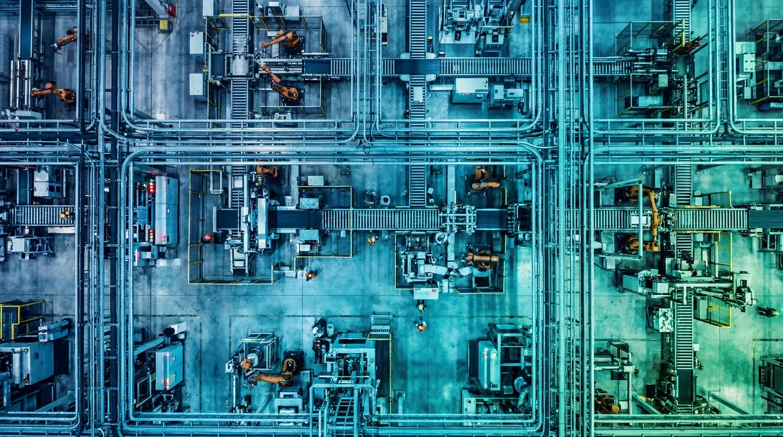 Aerial overhead view of an industrial OT manufacturing facility with teal cybersecurity gradient overlay showing complex piping networks and machinery