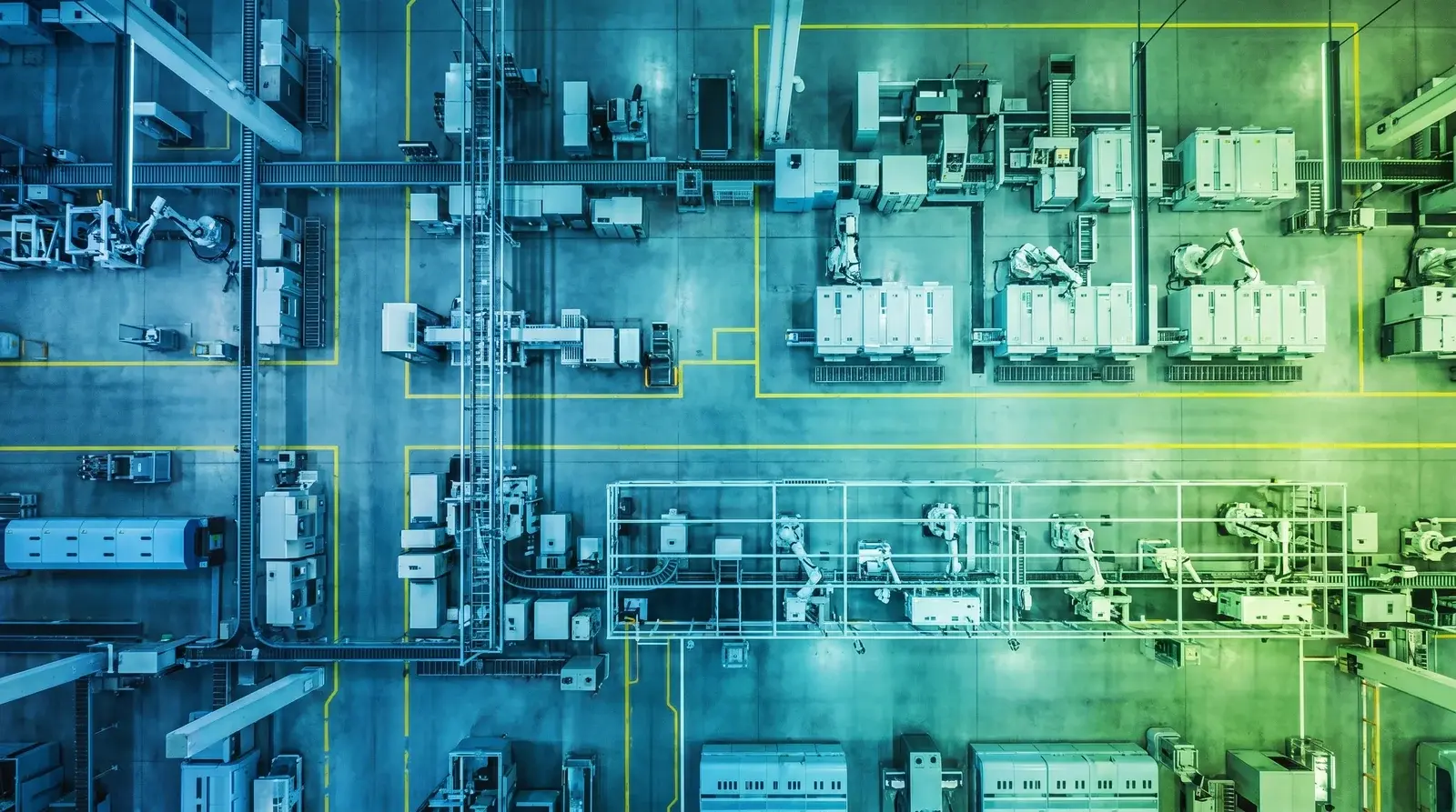 Aerial view of a smart manufacturing factory floor with robotic production lines, illustrating manufacturing cybersecurity